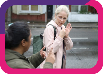Photograph of two women communicating by British Sign Language