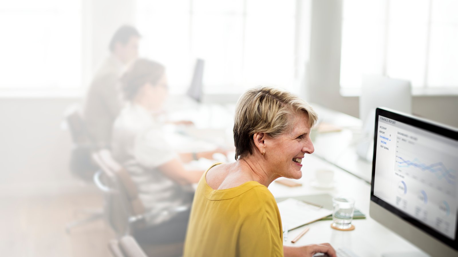 Smiling worker engaged with report showing good performance